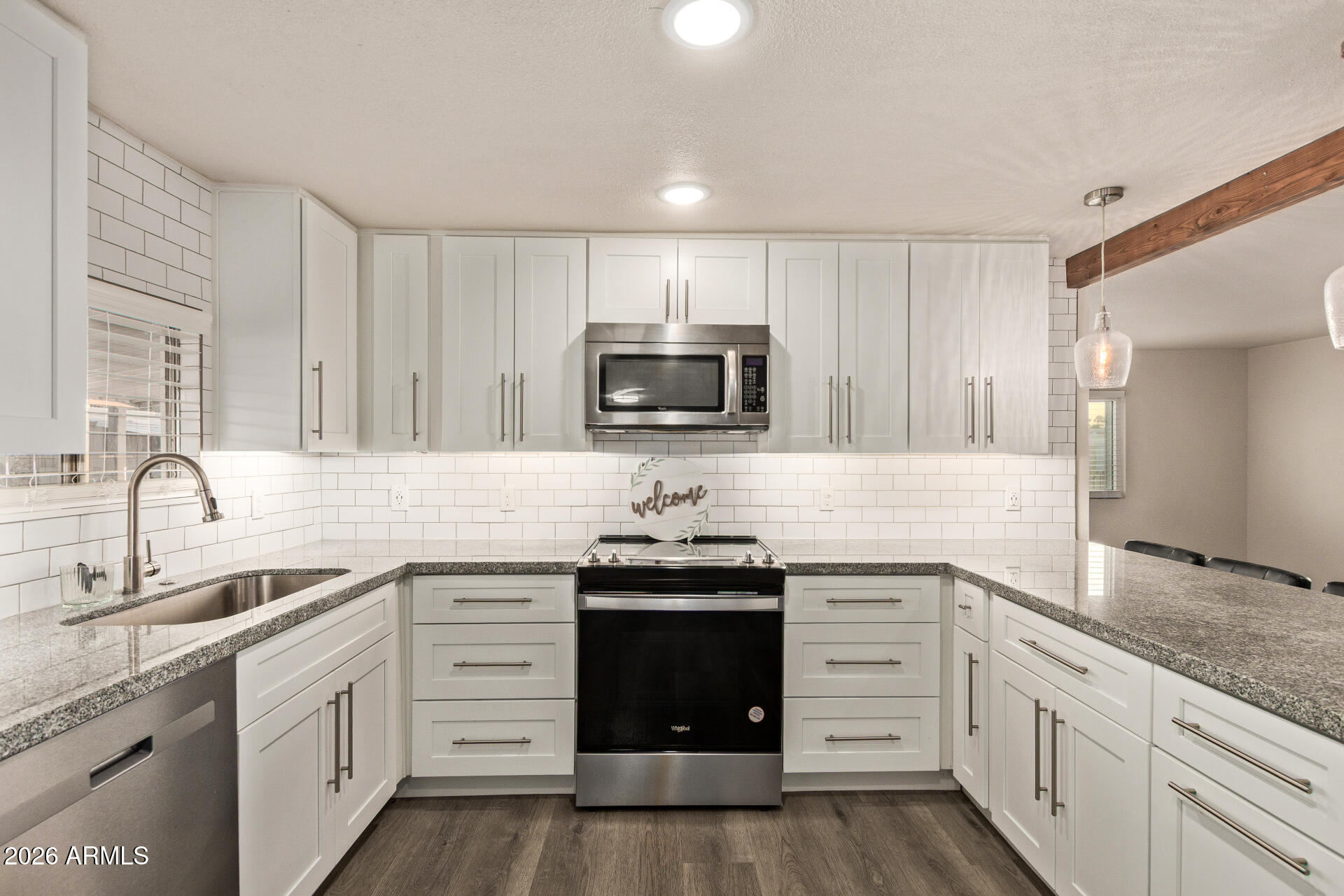 400 West Baseline Road, Unit 312 Tempe, AZ 85283 - Photo 3 of 32 a kitchen with granite countertop white cabinets and stainless steel appliances