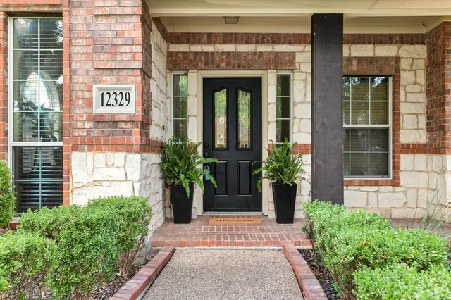 a dining room with furniture a chandelier and wooden floor