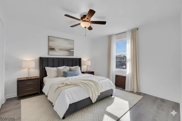 a bedroom with a bed and a painting on the wall