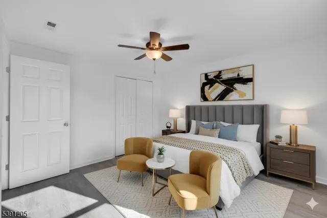 a bedroom with a bed a couch and painting on the wall