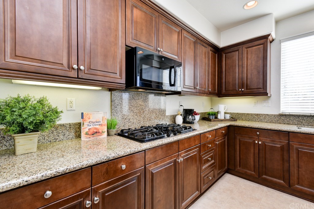 14383 Pointer Loop Eastvale, CA 92880 - Photo 1 of 1 a kitchen with stainless steel appliances granite countertop a sink a stove and cabinets