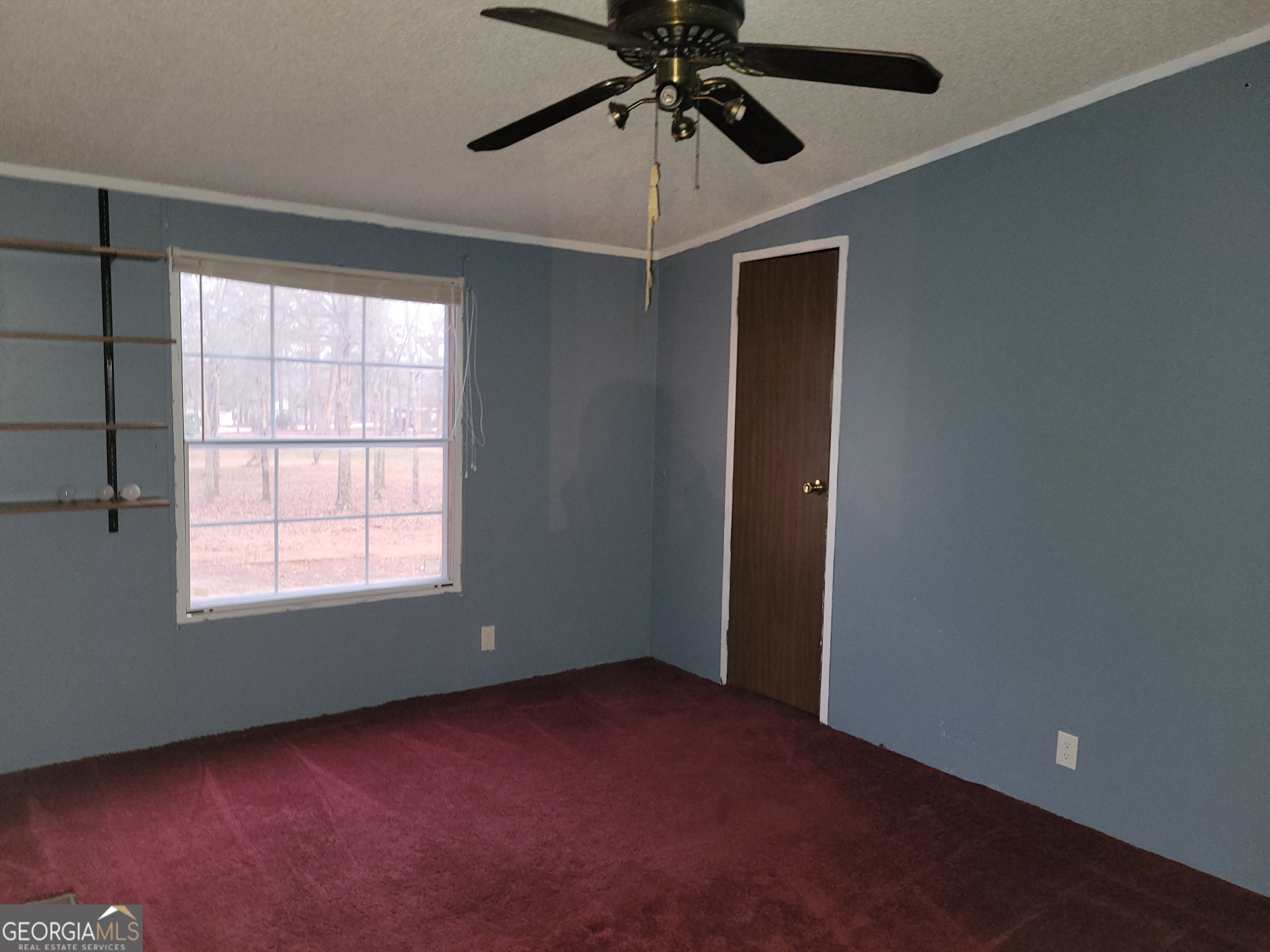 8449 Lee Road Salem, AL 36874 - Photo 22 of 26 an empty room with a window and a fan