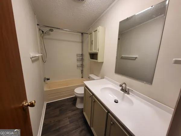 a bathroom with a sink toilet tub and shower