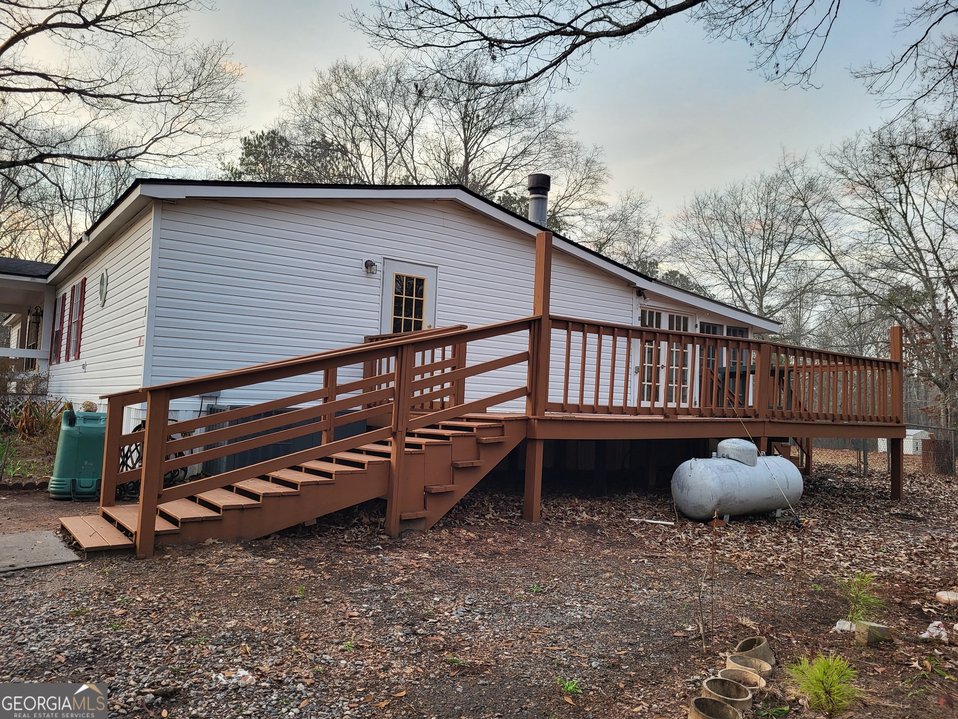 8449 Lee Road Salem, AL 36874 - Photo 4 of 26 a backyard of a house with barbeque oven table and chairs