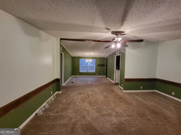 a view of a livingroom with a ceiling fan and window