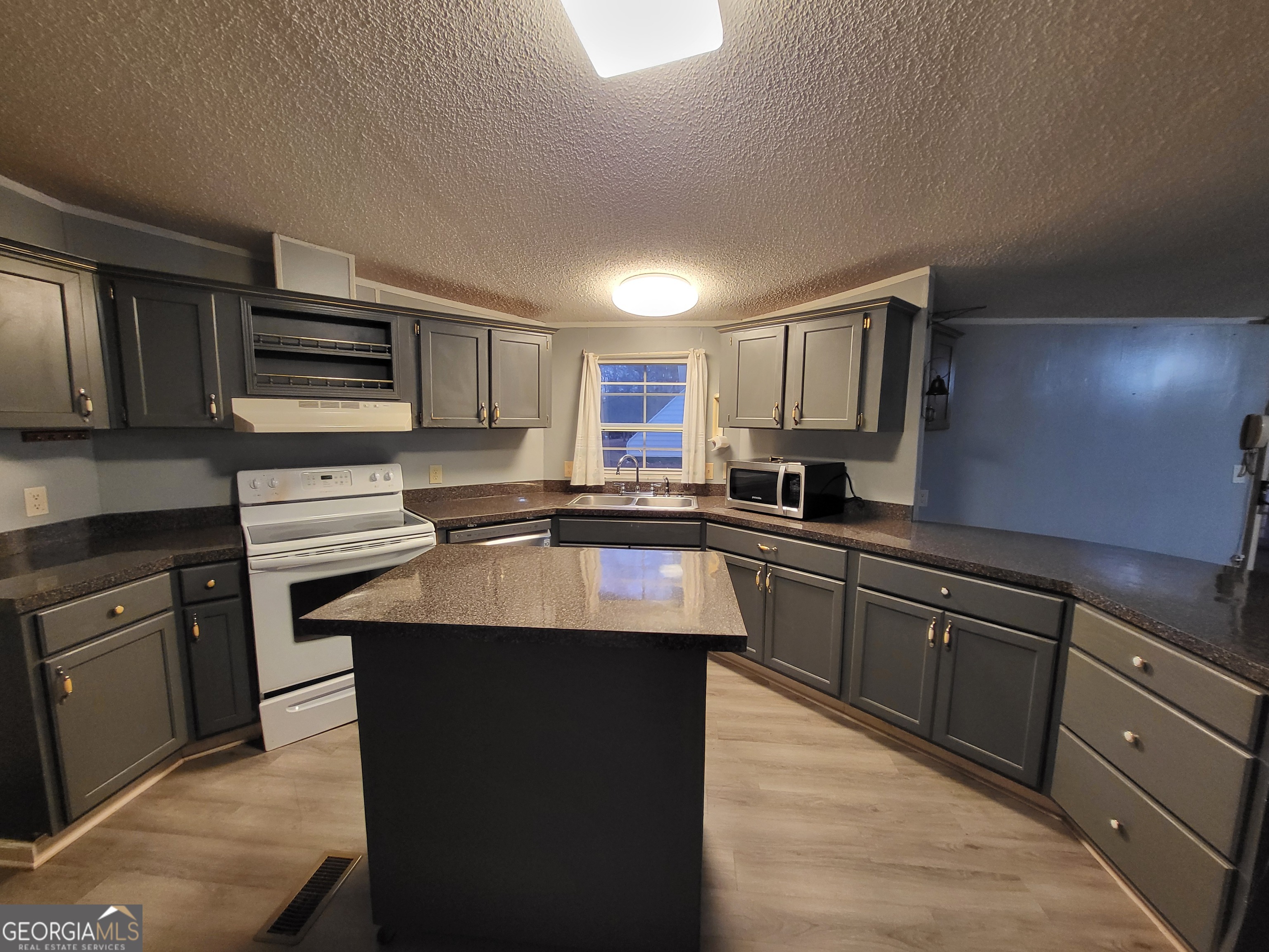 8449 Lee Road Salem, AL 36874 - Photo 9 of 26 a kitchen with stainless steel appliances granite countertop a sink stove microwave and cabinets