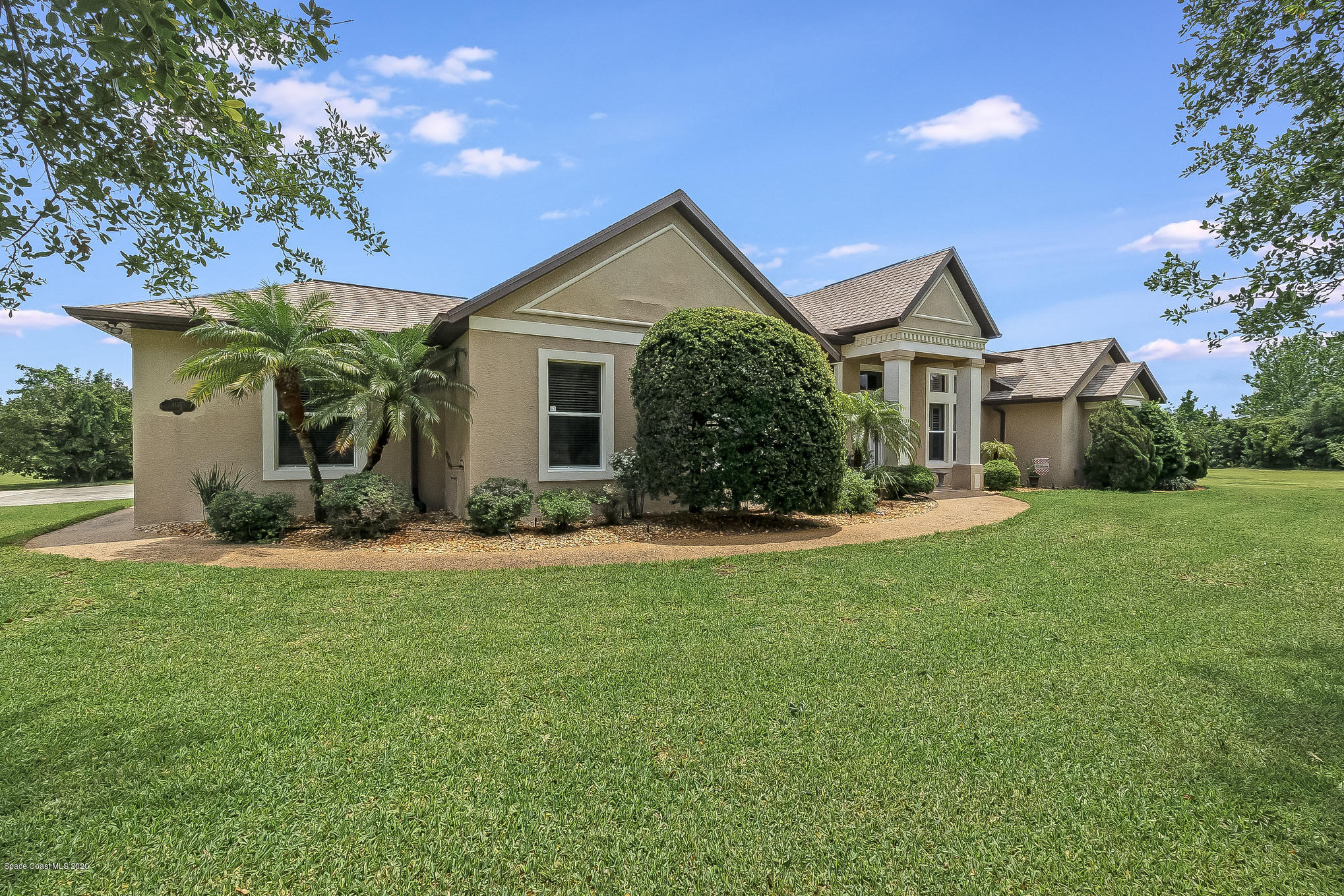 4135 Hammock Road Mims, FL 32754 - Photo 3 of 42 a front view of house with yard and green space