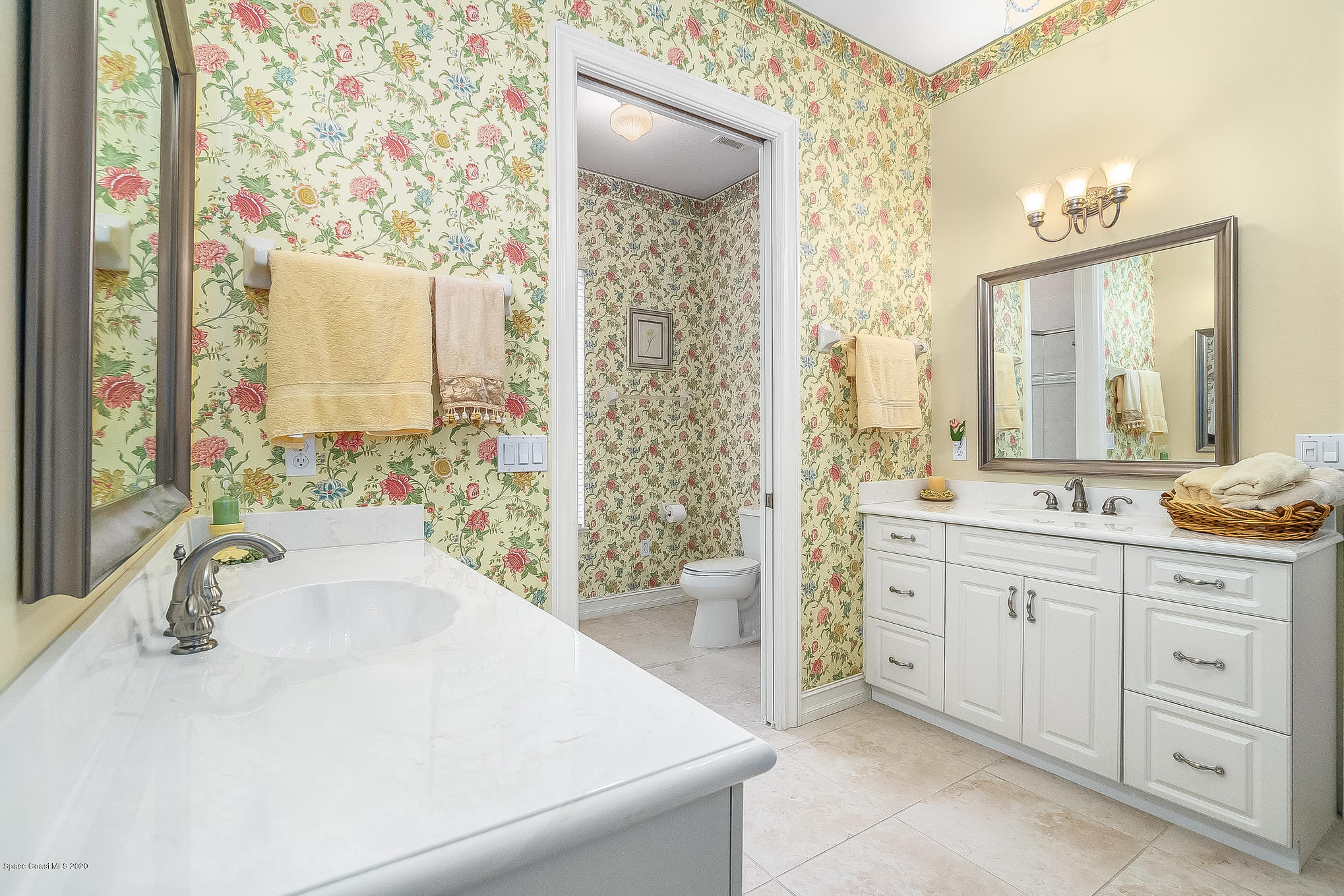 4135 Hammock Road Mims, FL 32754 - Photo 22 of 42 a spacious bathroom with a double vanity sink a mirror a next to a window