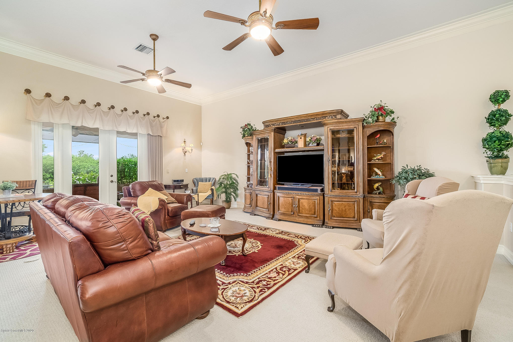 4135 Hammock Road Mims, FL 32754 - Photo 8 of 42 a living room with furniture ceiling fan and a large window