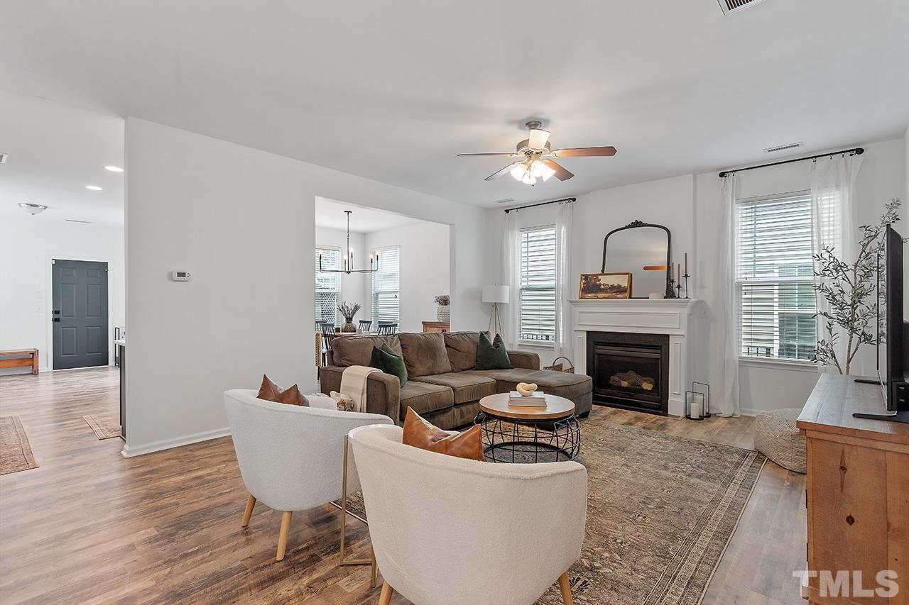 1028 Ileagnes Road Raleigh, NC 27603 - Photo 6 of 30 a living room with furniture a fireplace and a large window