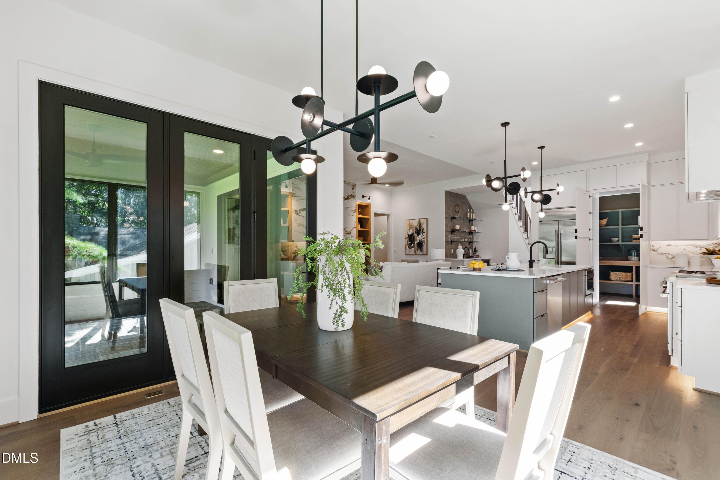 7809 Haymarket Lane Raleigh, NC 27615 - Photo 12 of 62 a view of a dining room and livingroom with furniture wooden floor a chandelier