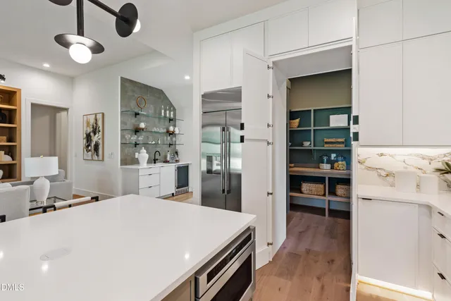 a living room with furniture a chandelier and a flat screen tv