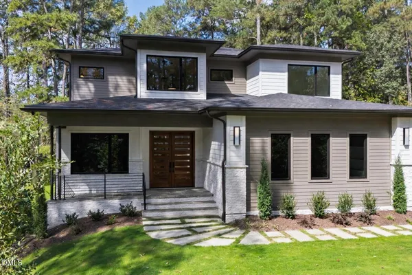 a kitchen with a table chairs appliances and cabinets