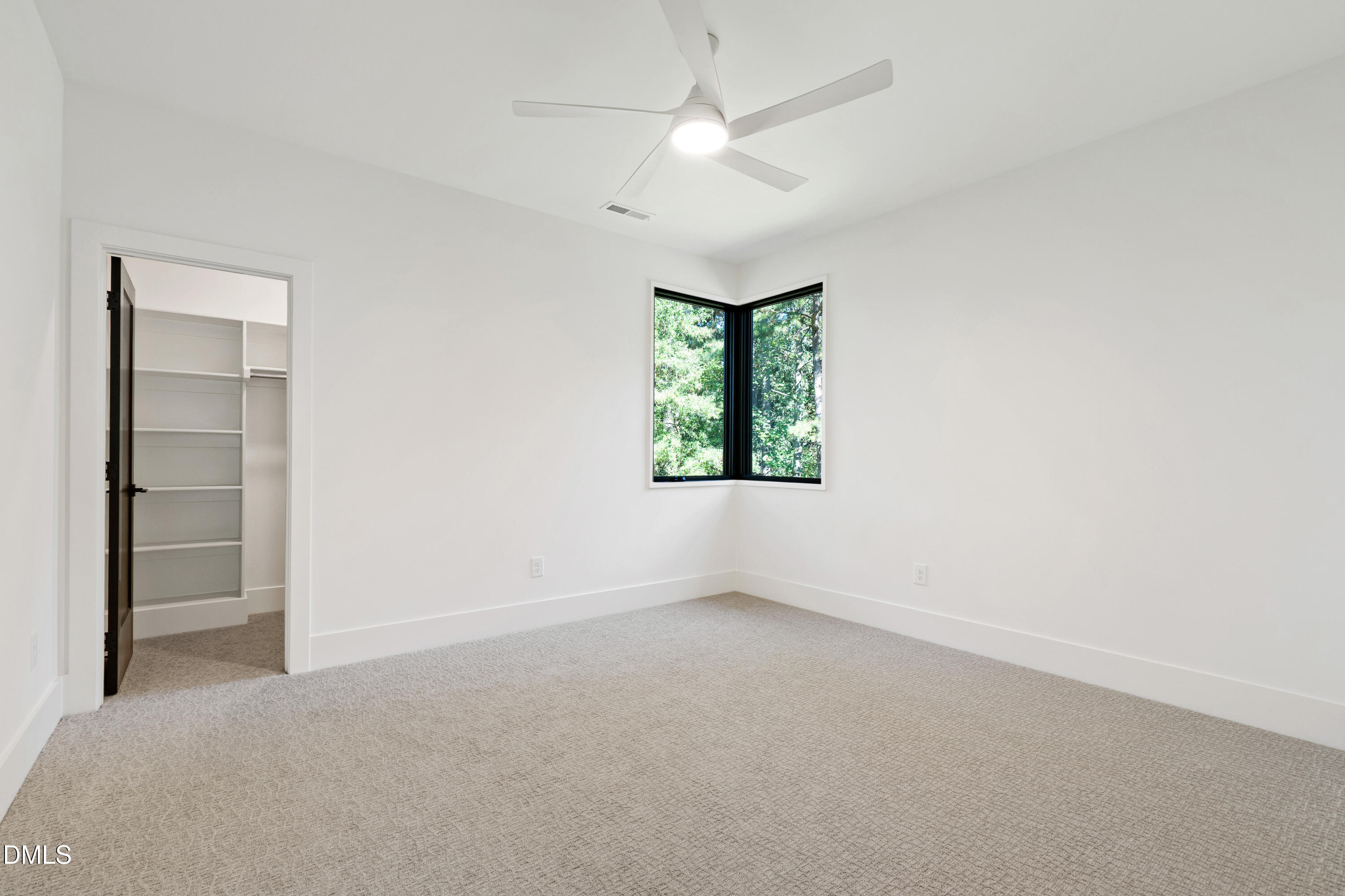 7809 Haymarket Lane Raleigh, NC 27615 - Photo 46 of 62 an empty room with a window and a ceiling fan