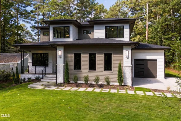 a view of a dining room and livingroom with furniture wooden floor a chandelier