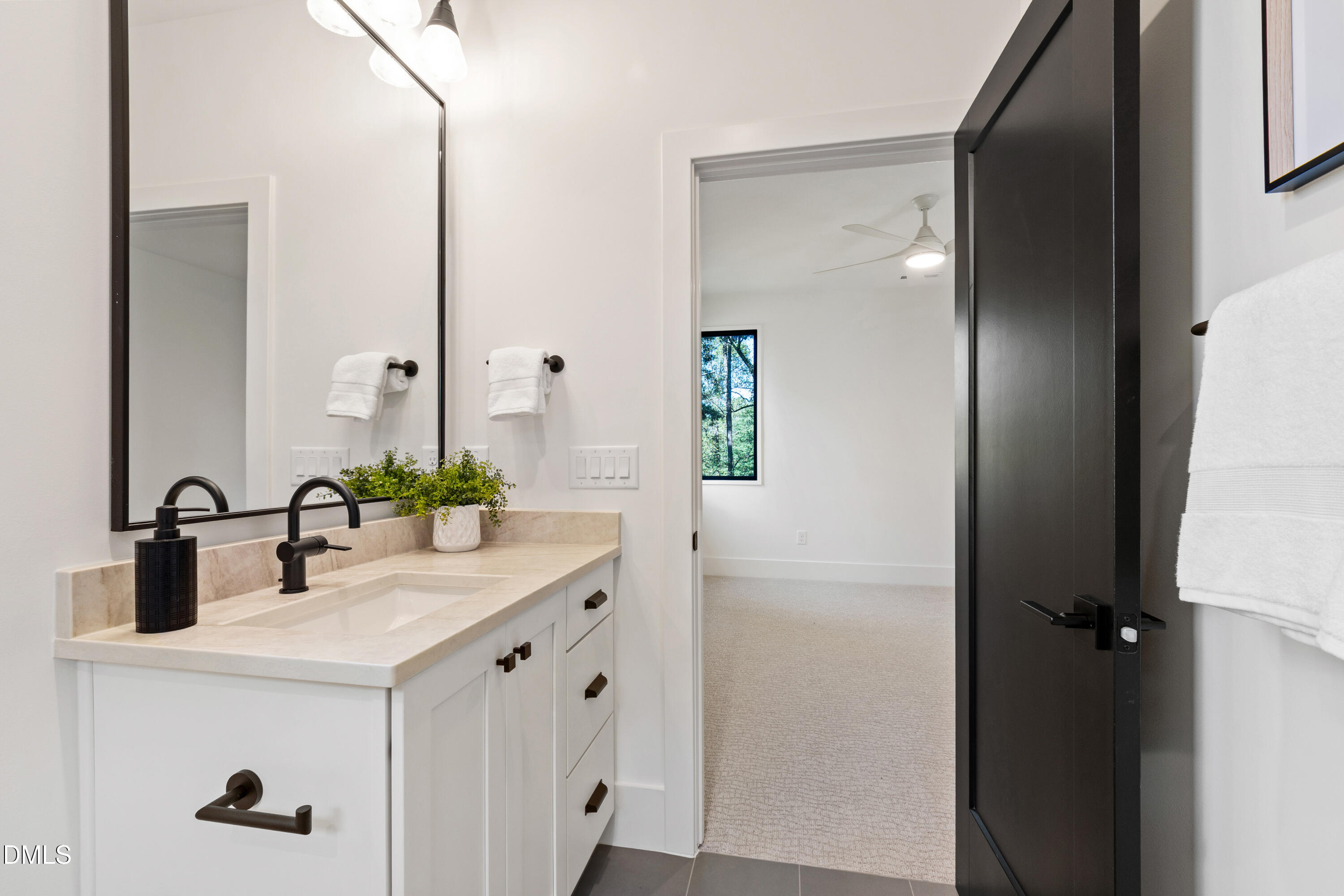 7809 Haymarket Lane Raleigh, NC 27615 - Photo 50 of 62 a bathroom with a sink and a mirror
