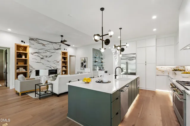 a kitchen with a sink a stove and a wooden floor