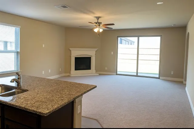 a kitchen with a granite countertop sink and a fireplace