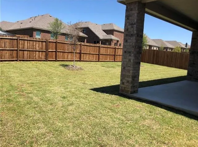 a view of a large building with a big yard and large trees