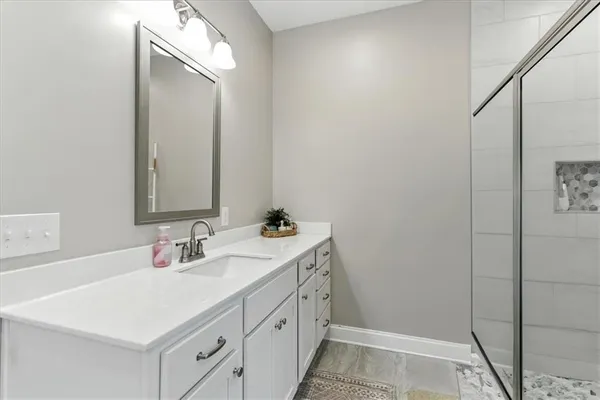 a bathroom with a toilet a sink a vanity and mirror