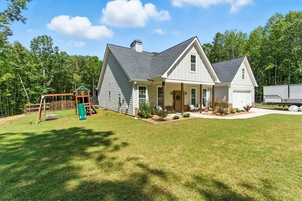 a view of a house with a yard porch and sitting area