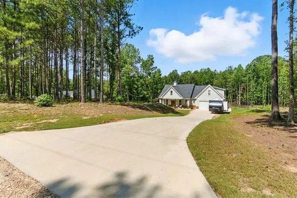 a front view of house with yard and green space