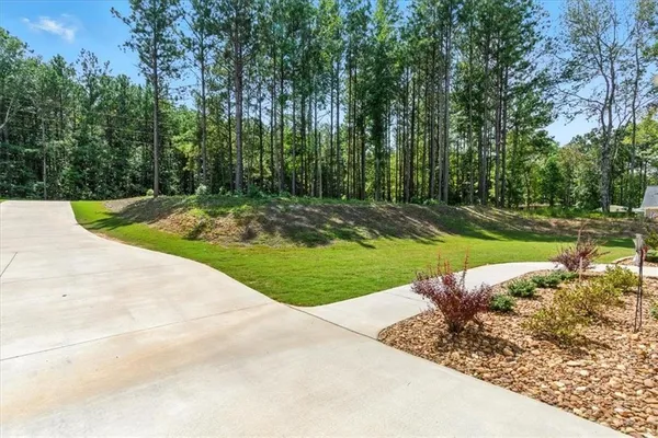 a view of a house with backyard sitting area and garden