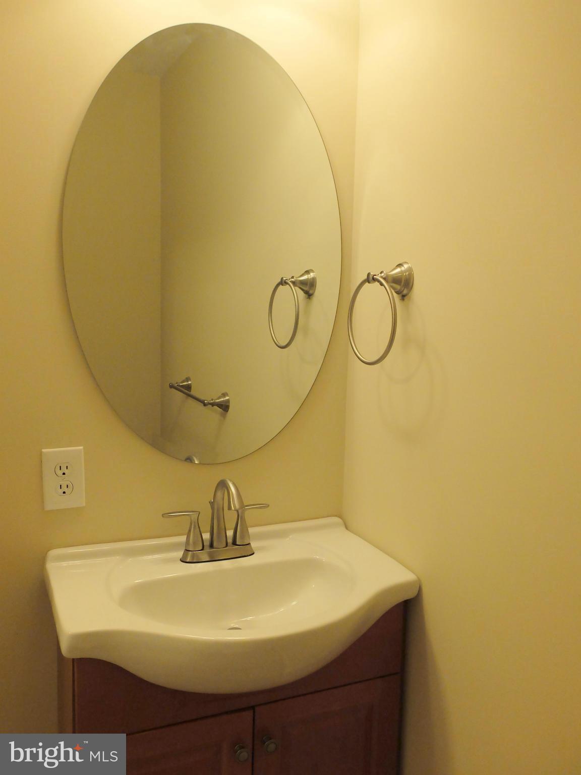 4922 Columbia Road, Unit 585 Columbia, MD 21044 - Photo 3 of 30 a bathroom with a sink and a mirror