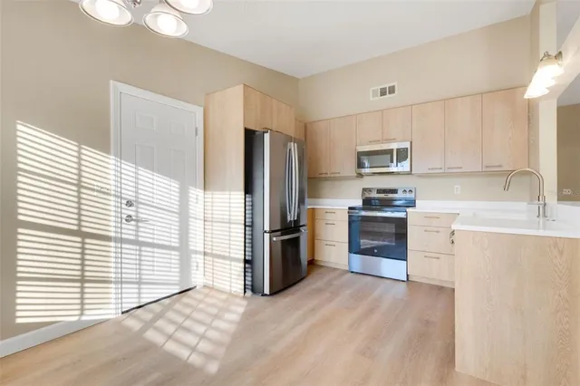 a kitchen with a refrigerator stove and sink