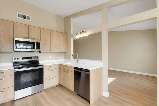 a kitchen with a sink stove and microwave