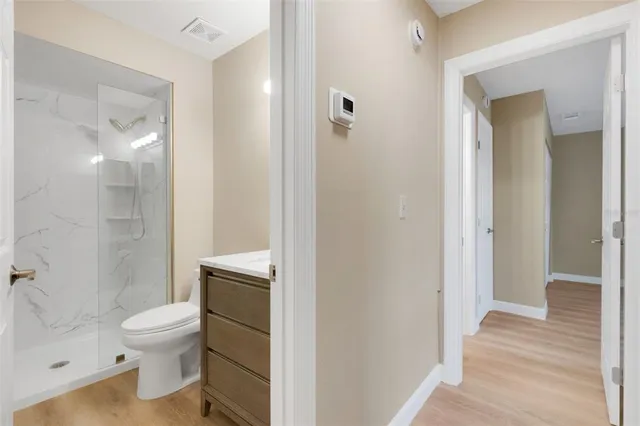 a bathroom with a toilet and a shower