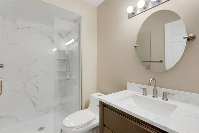 a bathroom with a sink toilet and shower