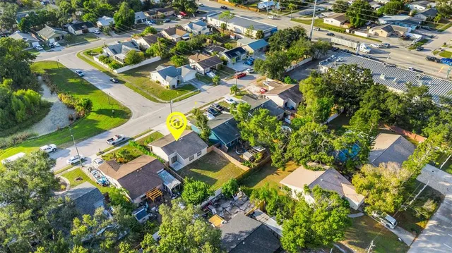 an aerial view of house with a yard and outdoor seating
