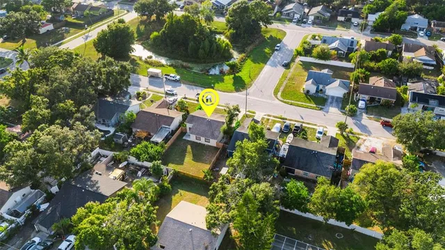 an aerial view of a house with a yard basket ball court and outdoor seating