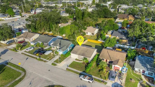 an aerial view of a house with a garden and lots of trees