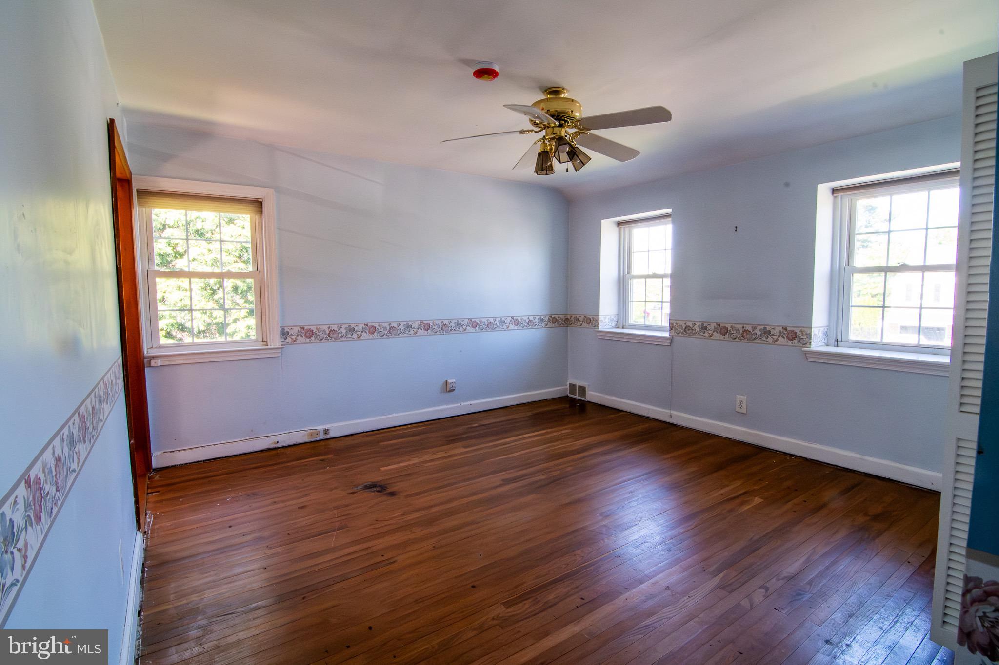 5004 Fairway Road Drexel Hill, PA 19026 - Photo 14 of 29 a view of an empty room with wooden floor and a window