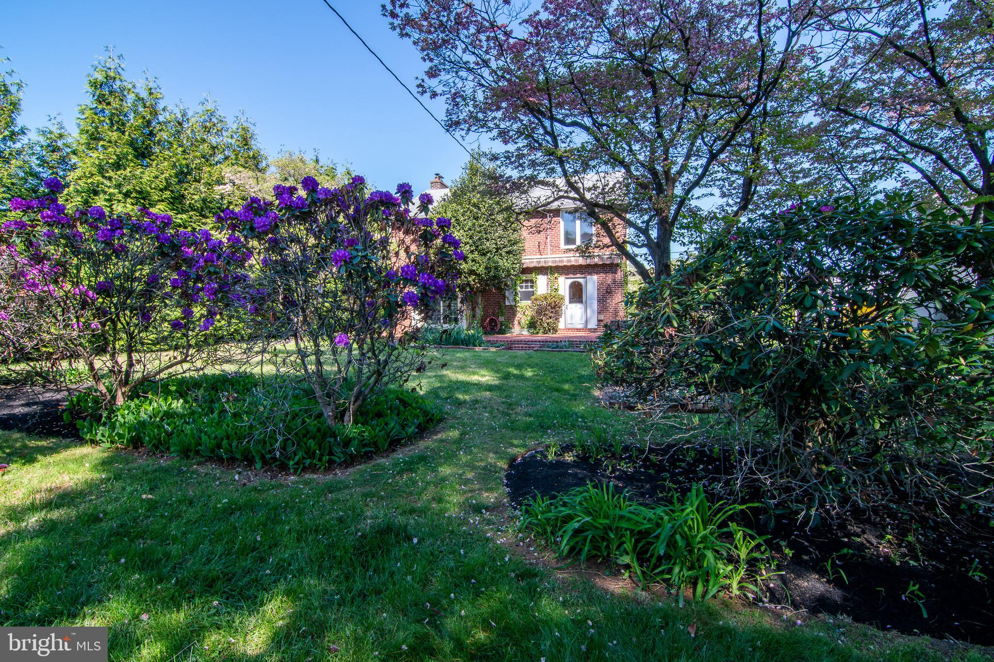 5004 Fairway Road Drexel Hill, PA 19026 - Photo 23 of 29 a view of a house with a big yard and flower plants