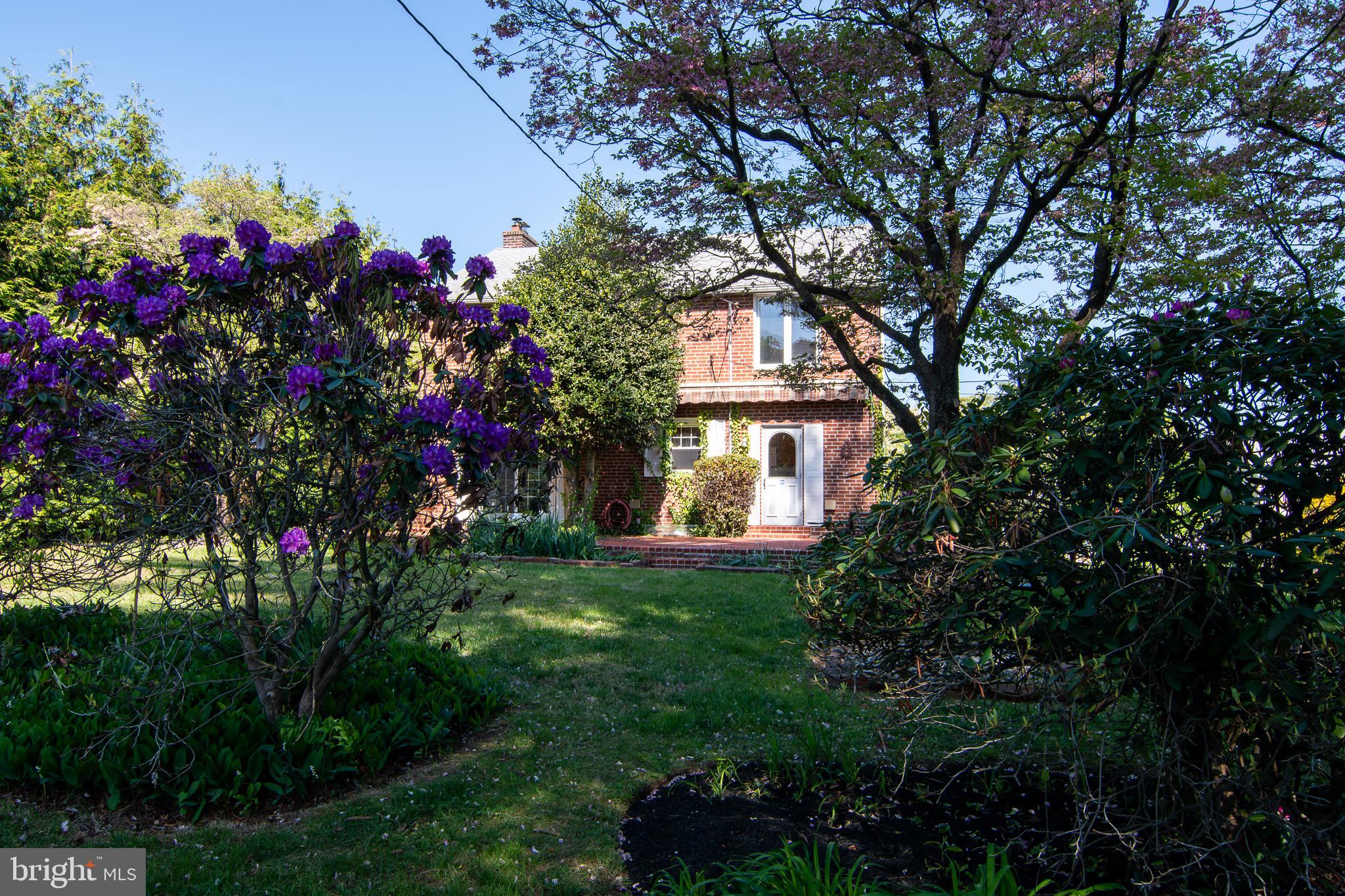 5004 Fairway Road Drexel Hill, PA 19026 - Photo 24 of 29 a front view of a house with lots of flower and trees