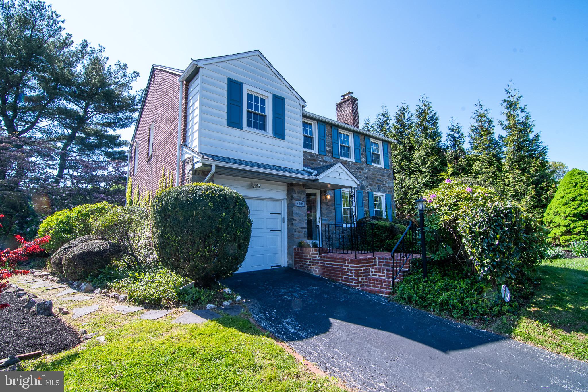 5004 Fairway Road Drexel Hill, PA 19026 - Photo 28 of 29 a view of a brick house with plants and large trees
