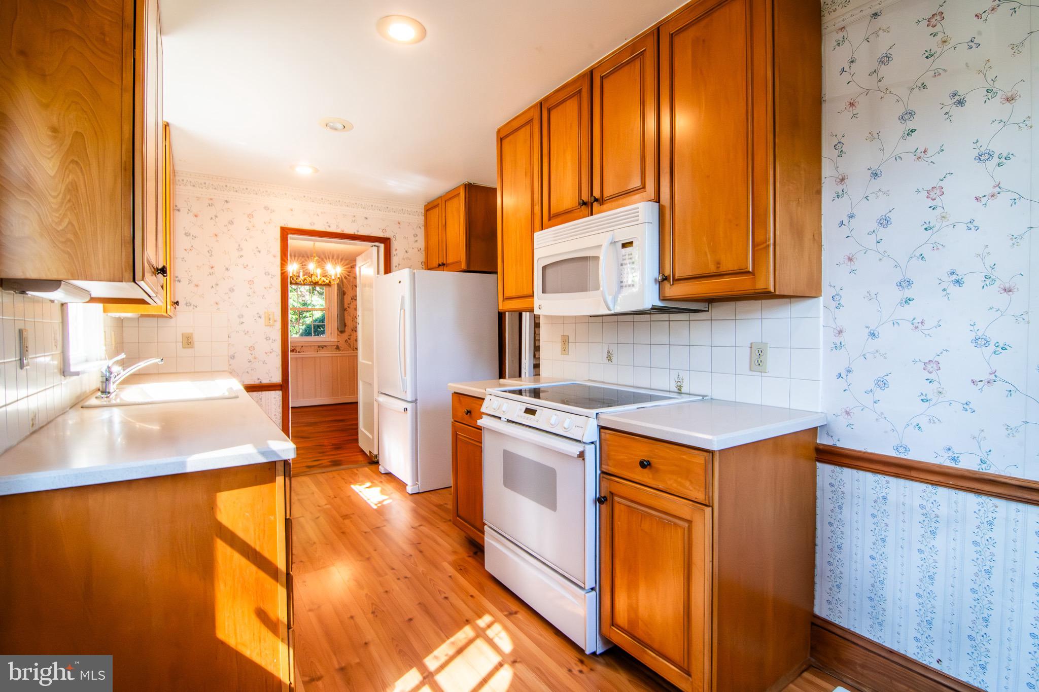 5004 Fairway Road Drexel Hill, PA 19026 - Photo 3 of 29 a kitchen with stainless steel appliances granite countertop a sink stove and refrigerator