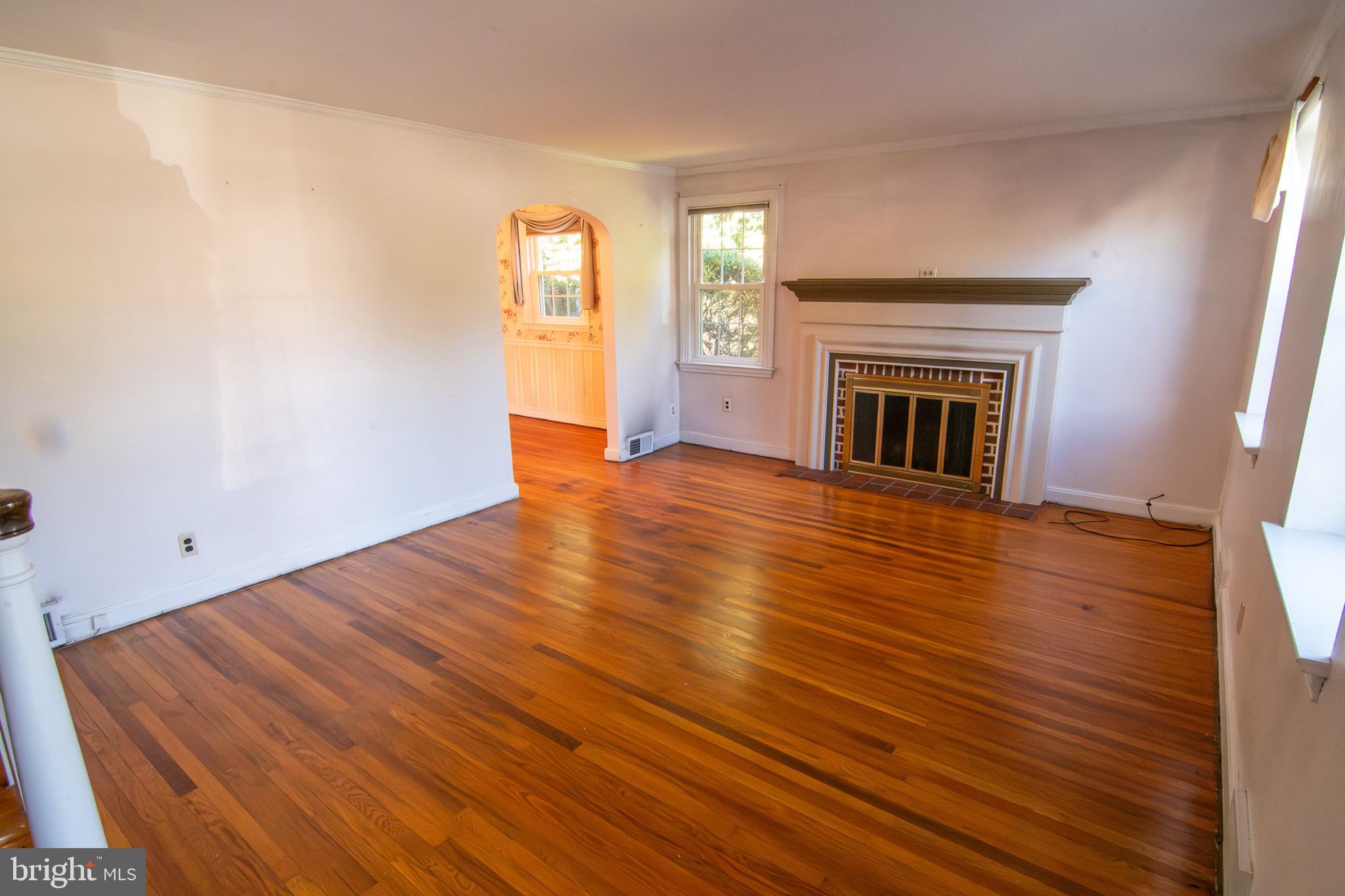 5004 Fairway Road Drexel Hill, PA 19026 - Photo 7 of 29 a view of empty room with wooden floor and fireplace