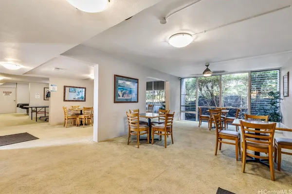 a living room with furniture and large windows