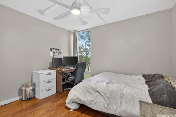 a bedroom with a bed and a tv