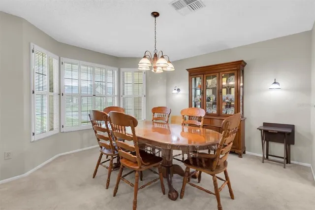 a dining room with furniture and window