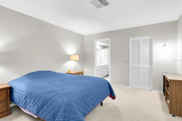 a bedroom with a bed and a lamp