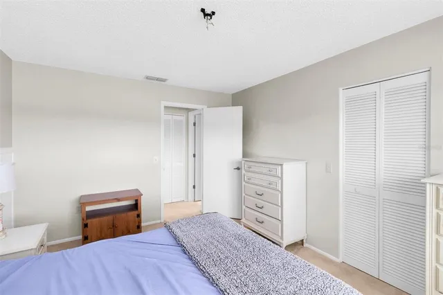 a bedroom with a bed and cabinets