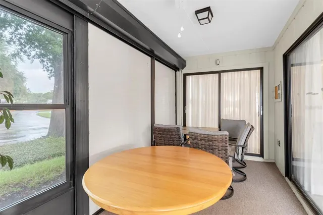 a view of a room with a large window and table
