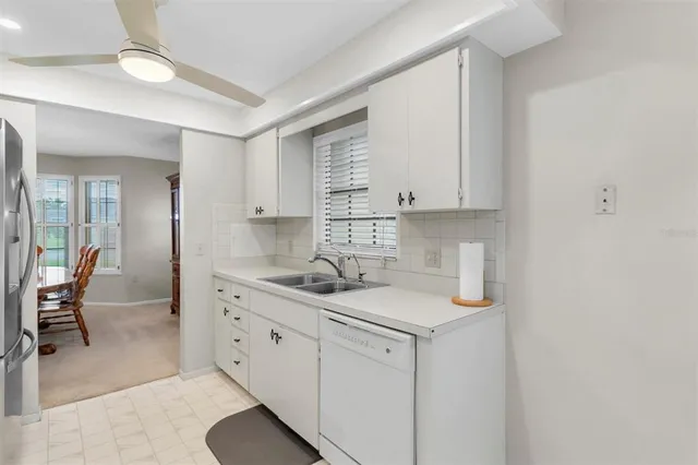 a kitchen with a sink cabinets and wooden floor