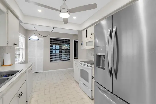a kitchen with stainless steel appliances a refrigerator sink and cabinets