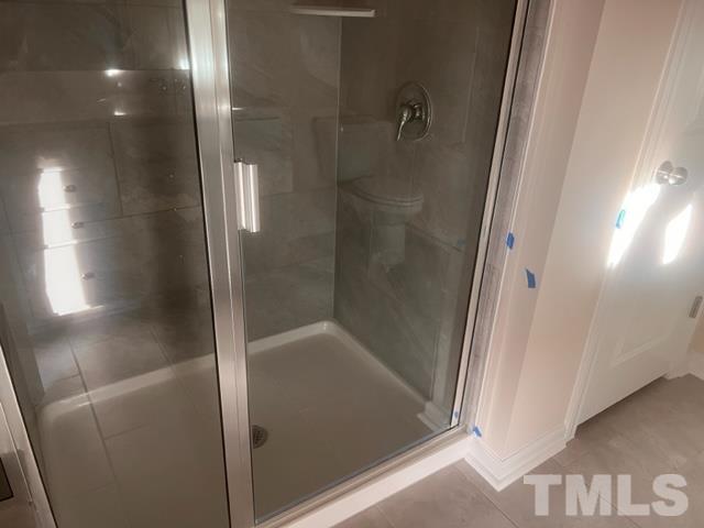 128 Katrine Way Raleigh, NC 27603 - Photo 12 of 19 a bathroom with a glass shower door